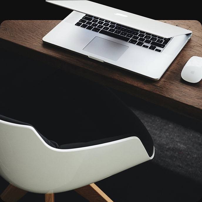 An office chair and a laptop on a table
